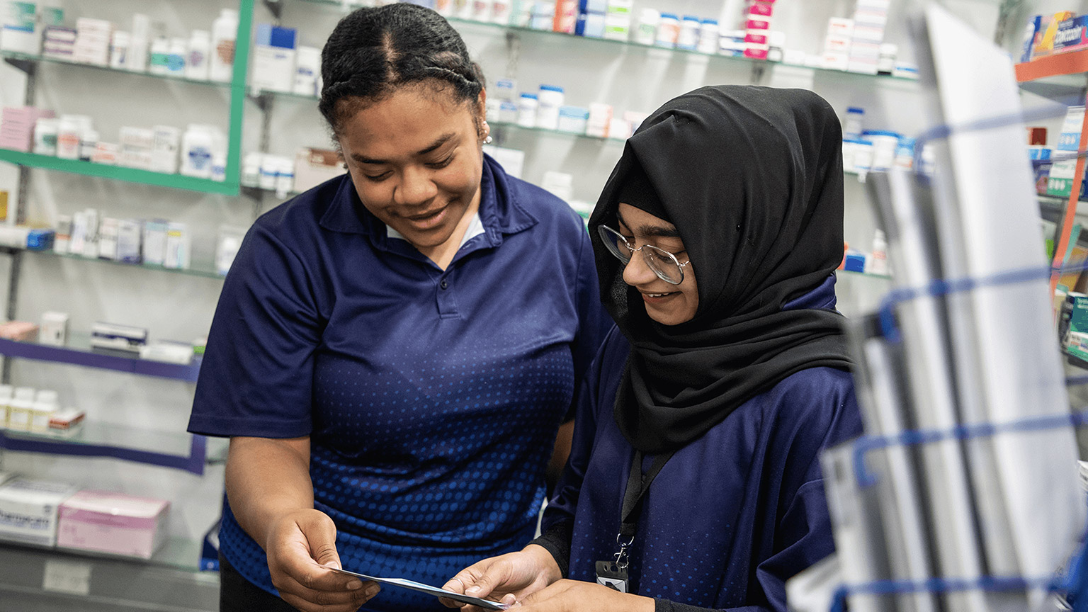 A pair of pharmacy students reading a prescription