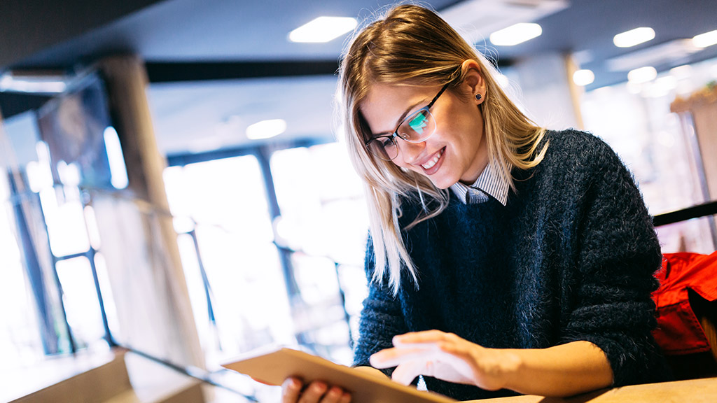 Portrait of young attractive woman using tablet