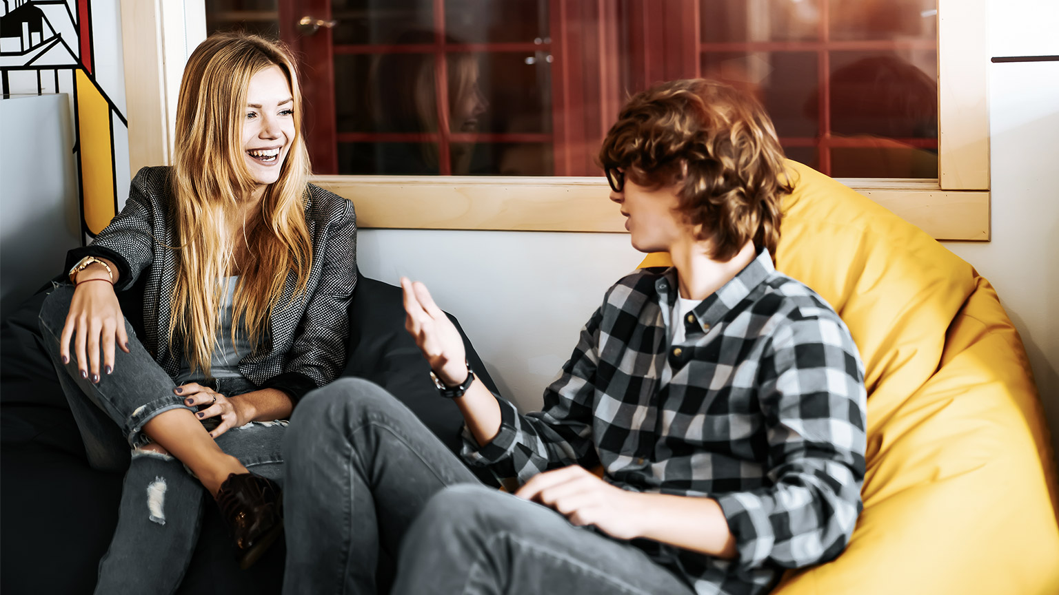 Cheerful woman talking with co-worker