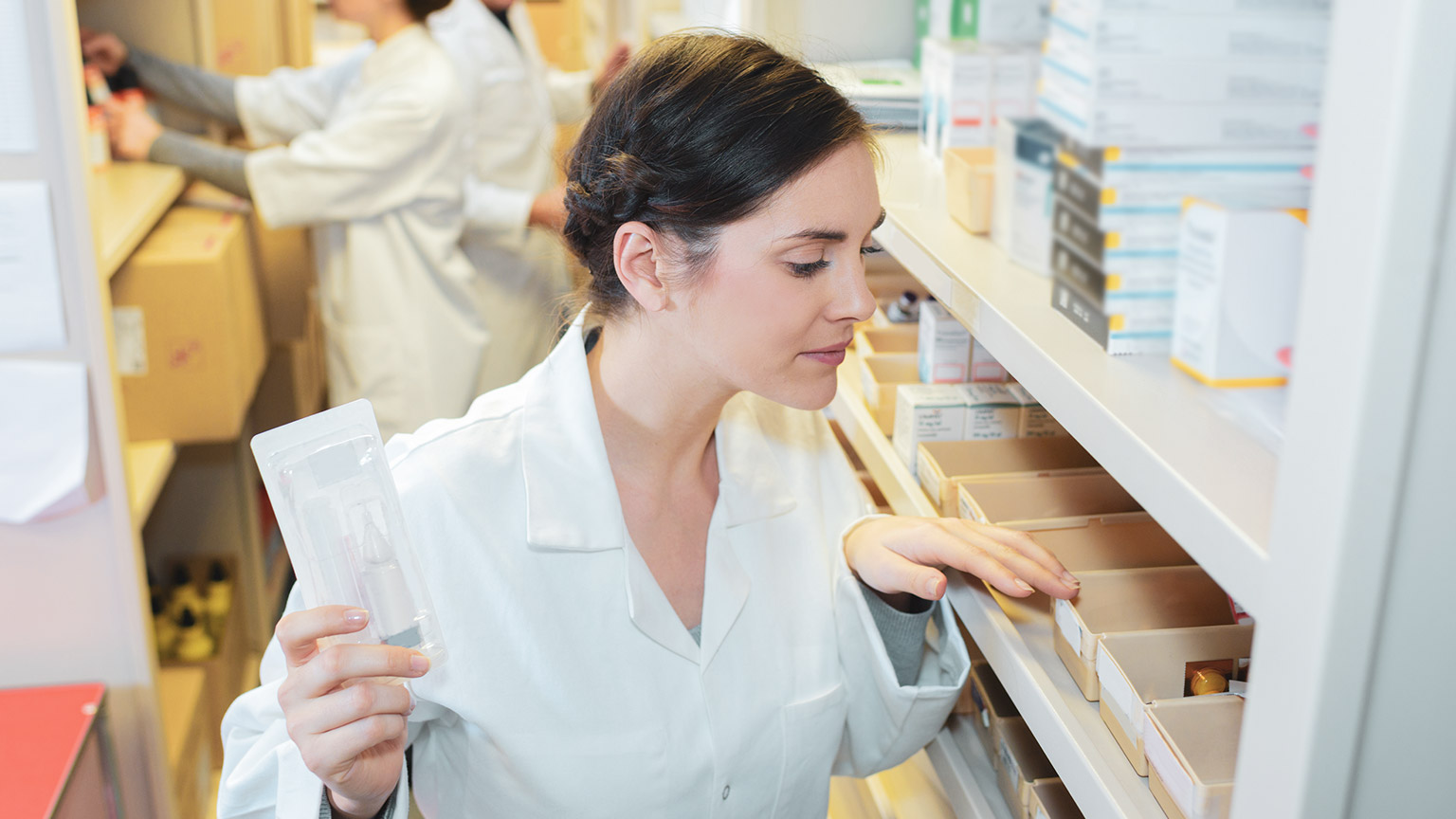 A pharmacist at work in a pharmacy