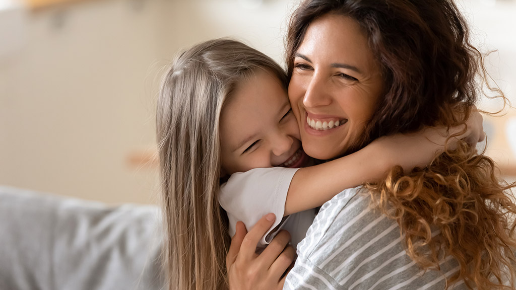 Cute little girl hug cuddle excited young mum show love and affection