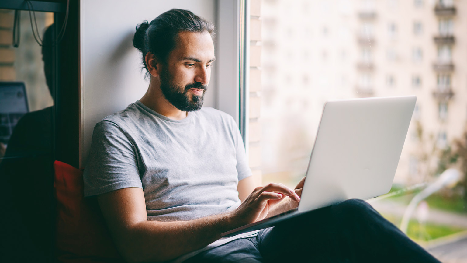 A person reading information on a laptop