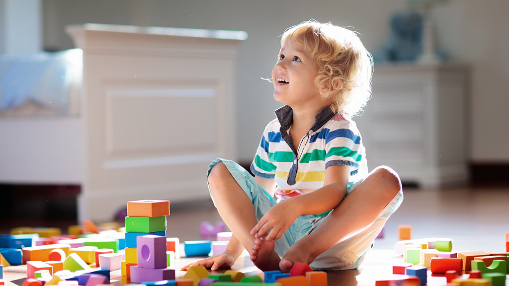 Child playing with colorful toy blocks