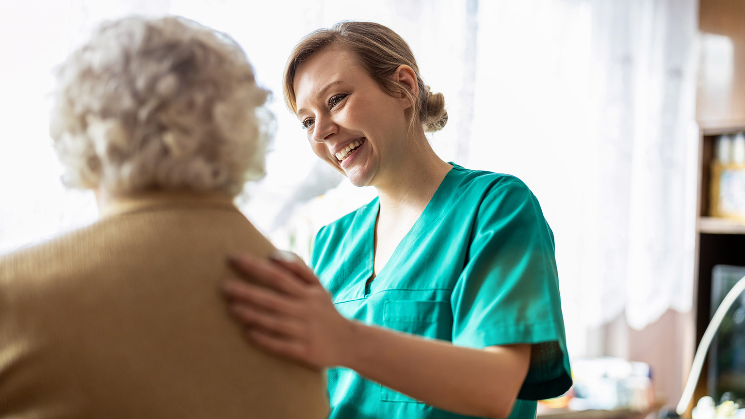 An aged care worker talking to a client