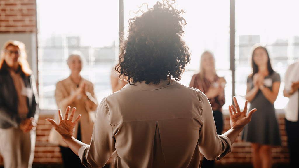 African american female empowering other colleagues in workplace