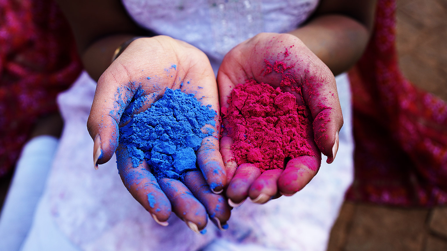  young woman playing holi festival with dry Colors