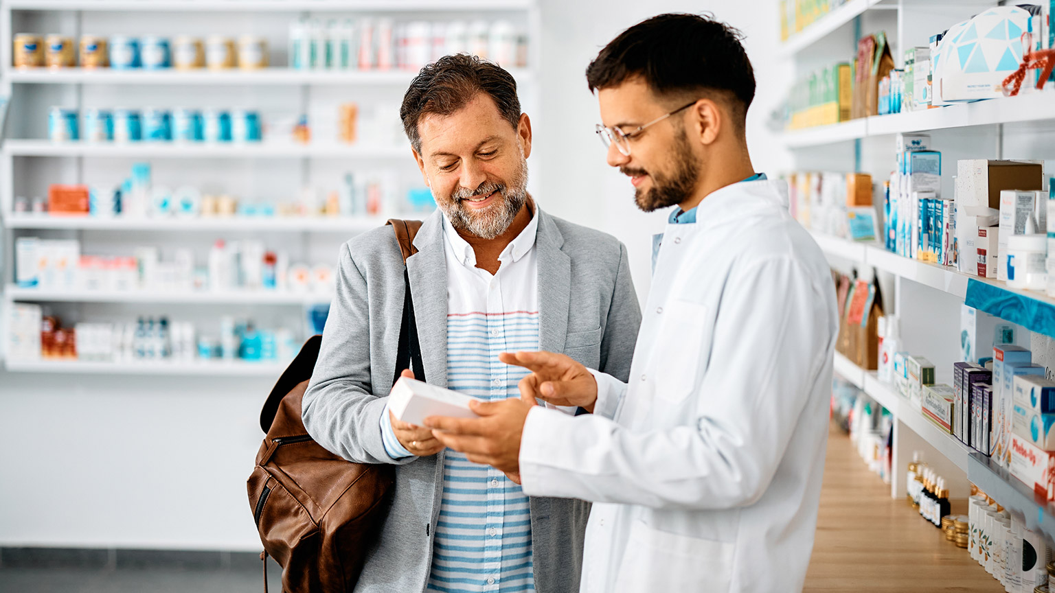 A pharmacist and client in a pharmacy