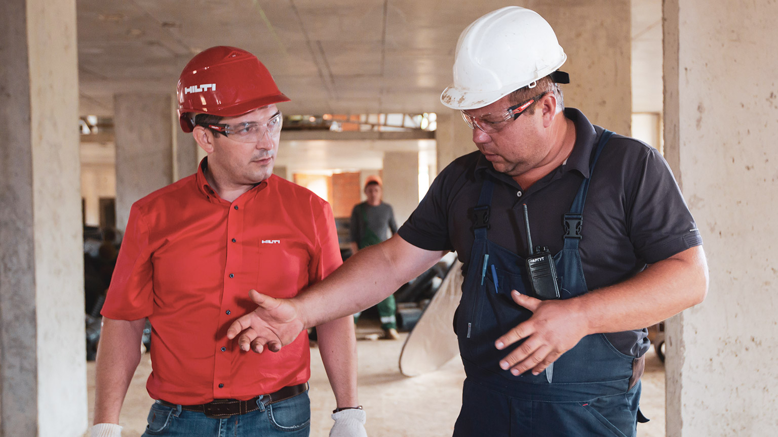 A person talking to a colleague on a building site