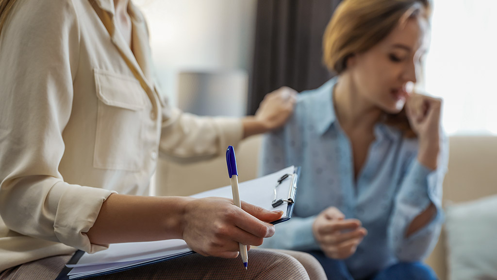 Professional psychotherapist and patient in office talking to her patient