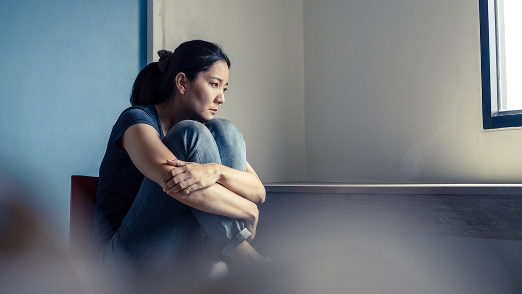 sad serious woman sitting alone