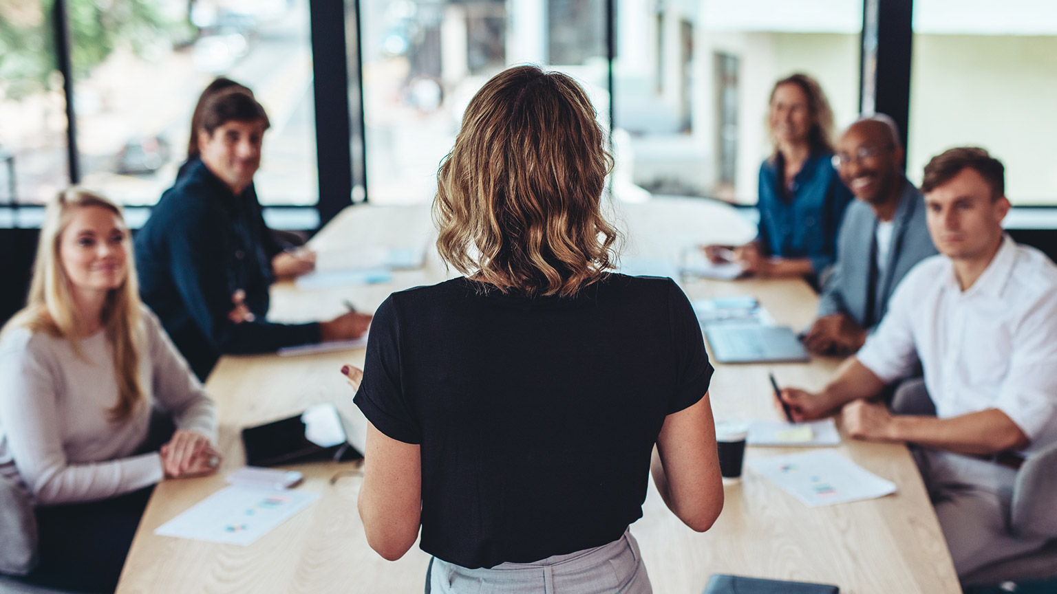 A person leading a team meeting in an office