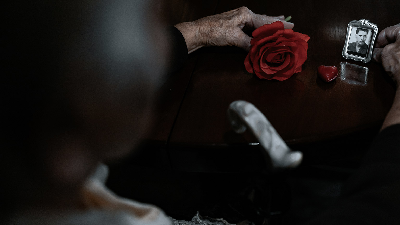 senior holding picture frame and flower