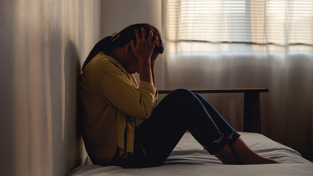 woman feeling sad, crying lonely in her room