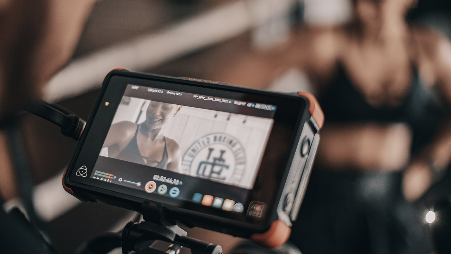 A video viewfinder on a camera creating a fitness marketing video