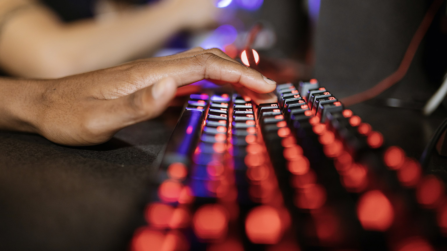 A close view of a person using a gaming keyboard