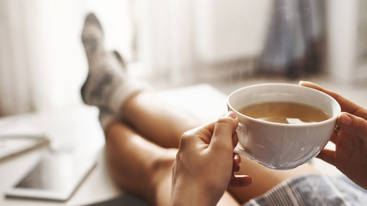 A person relaxing and drinking tea