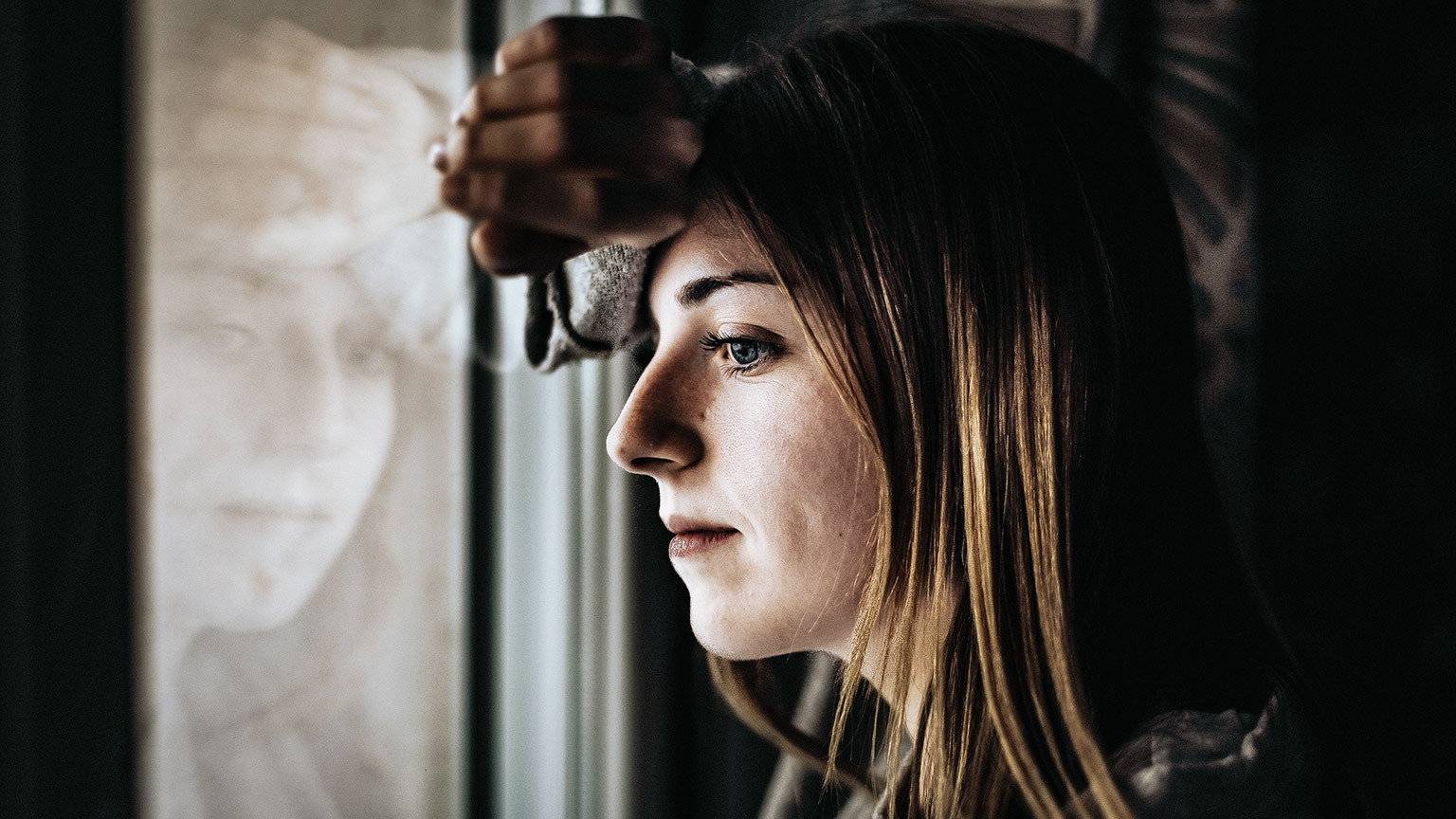 woman looking out the window