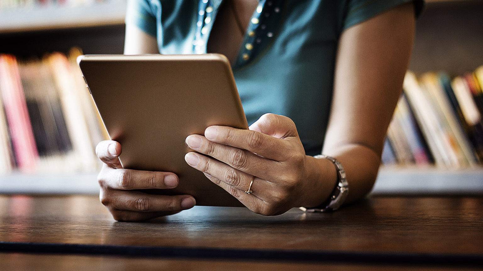 A person reading from an Ipad