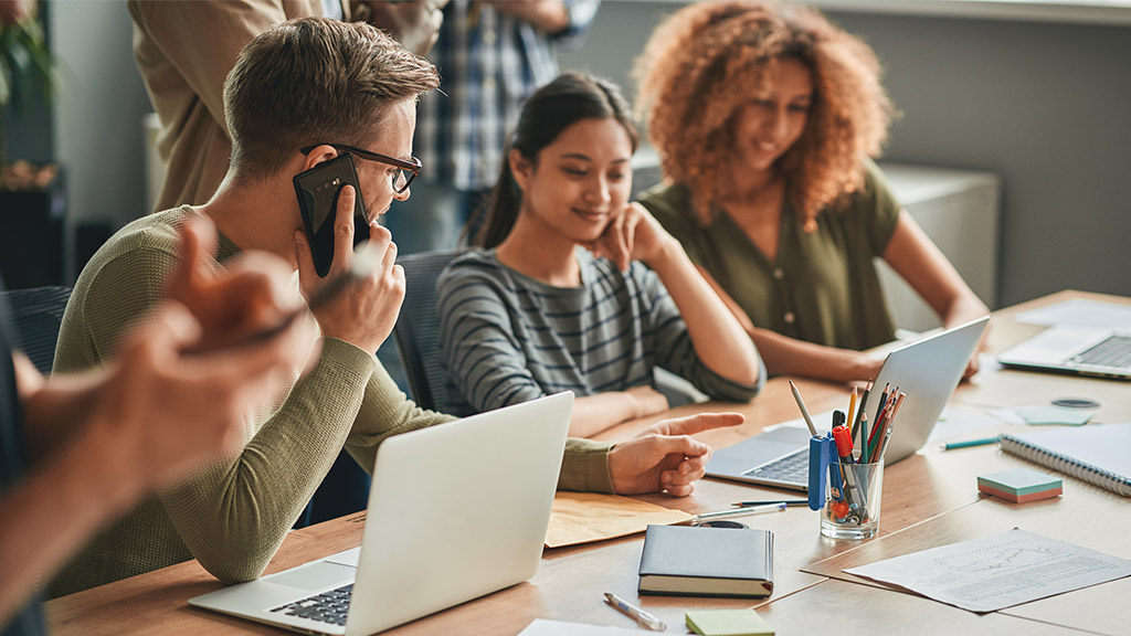 Ambitious man working side by side with young women