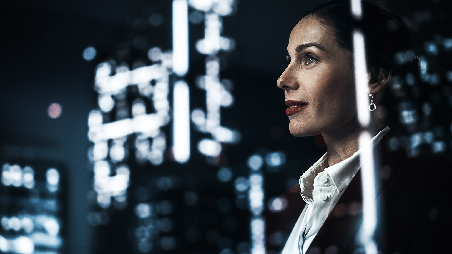 A woman looking up to the tall buildings through the office window