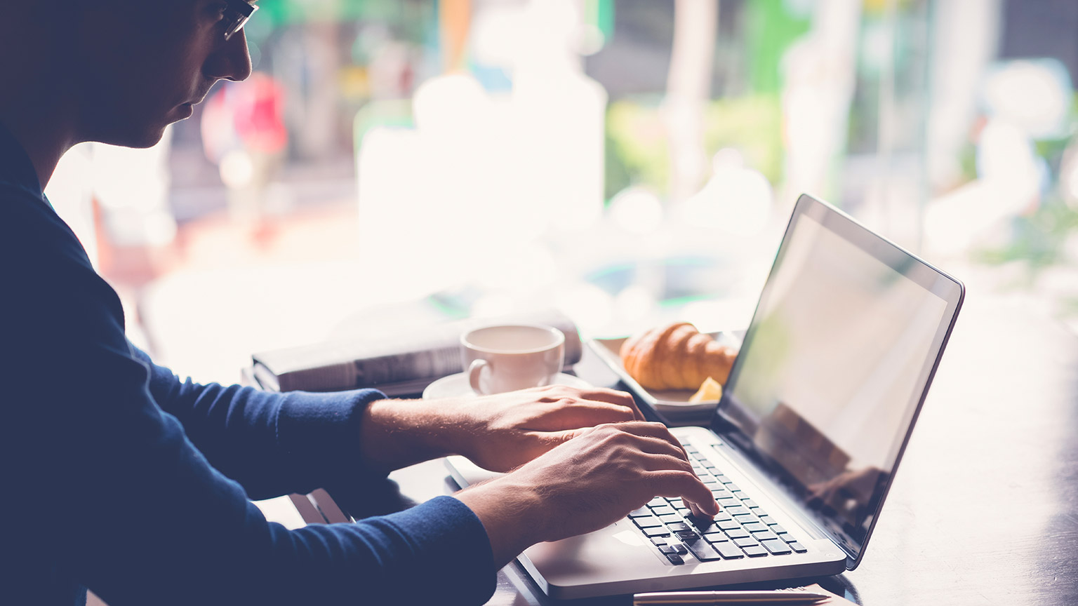 A person typing on a laptop