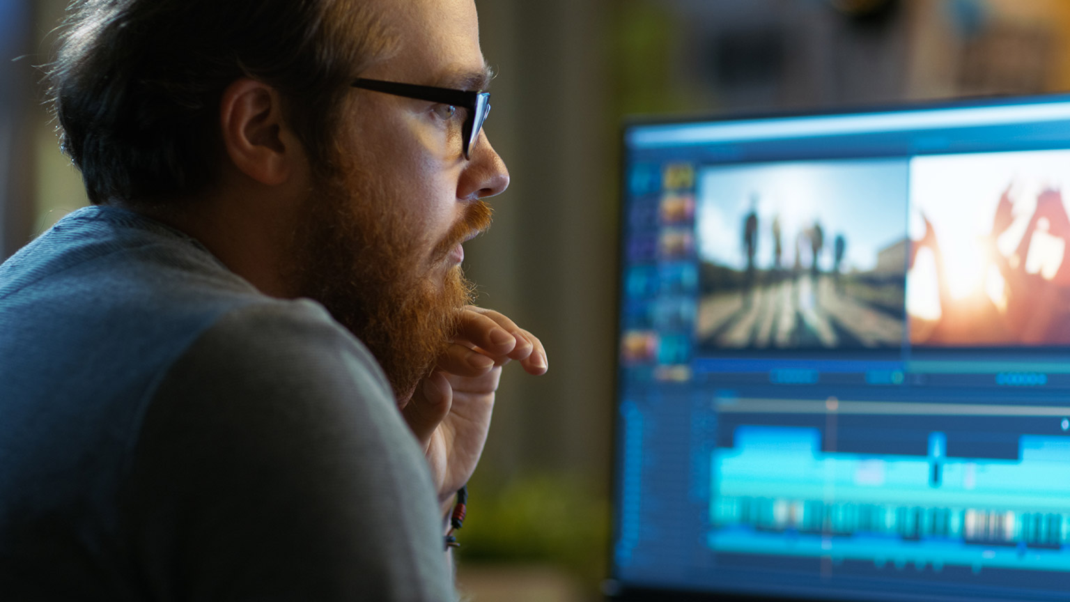 A video editor at work on a computer