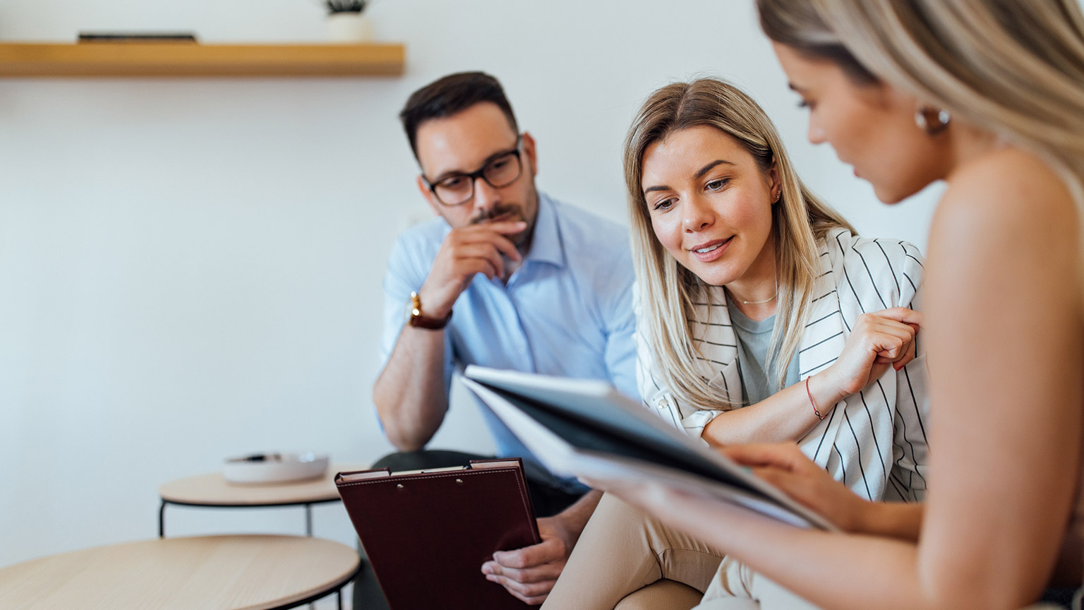 Colleagues discussing business in a modern office