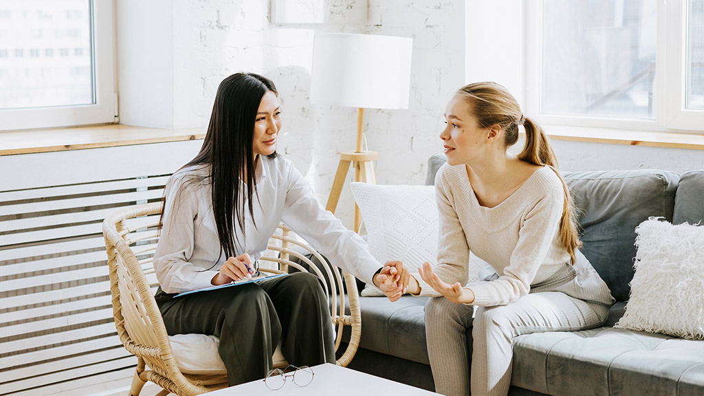 psychologist conducts a session for a patient at her office