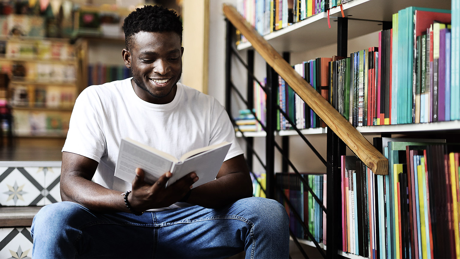 A person reading in a library steps