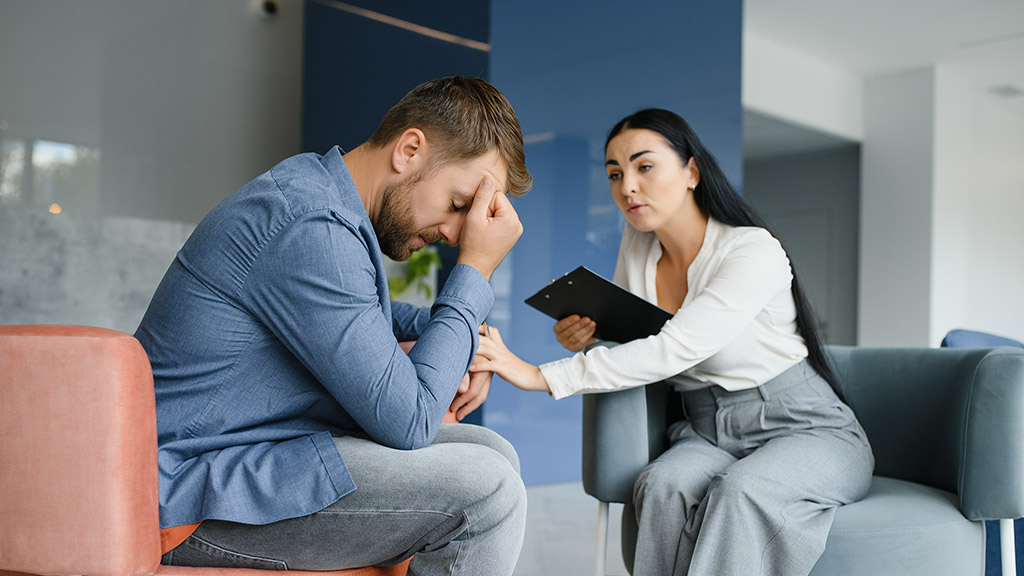 Psychologist talking with patient on therapy session