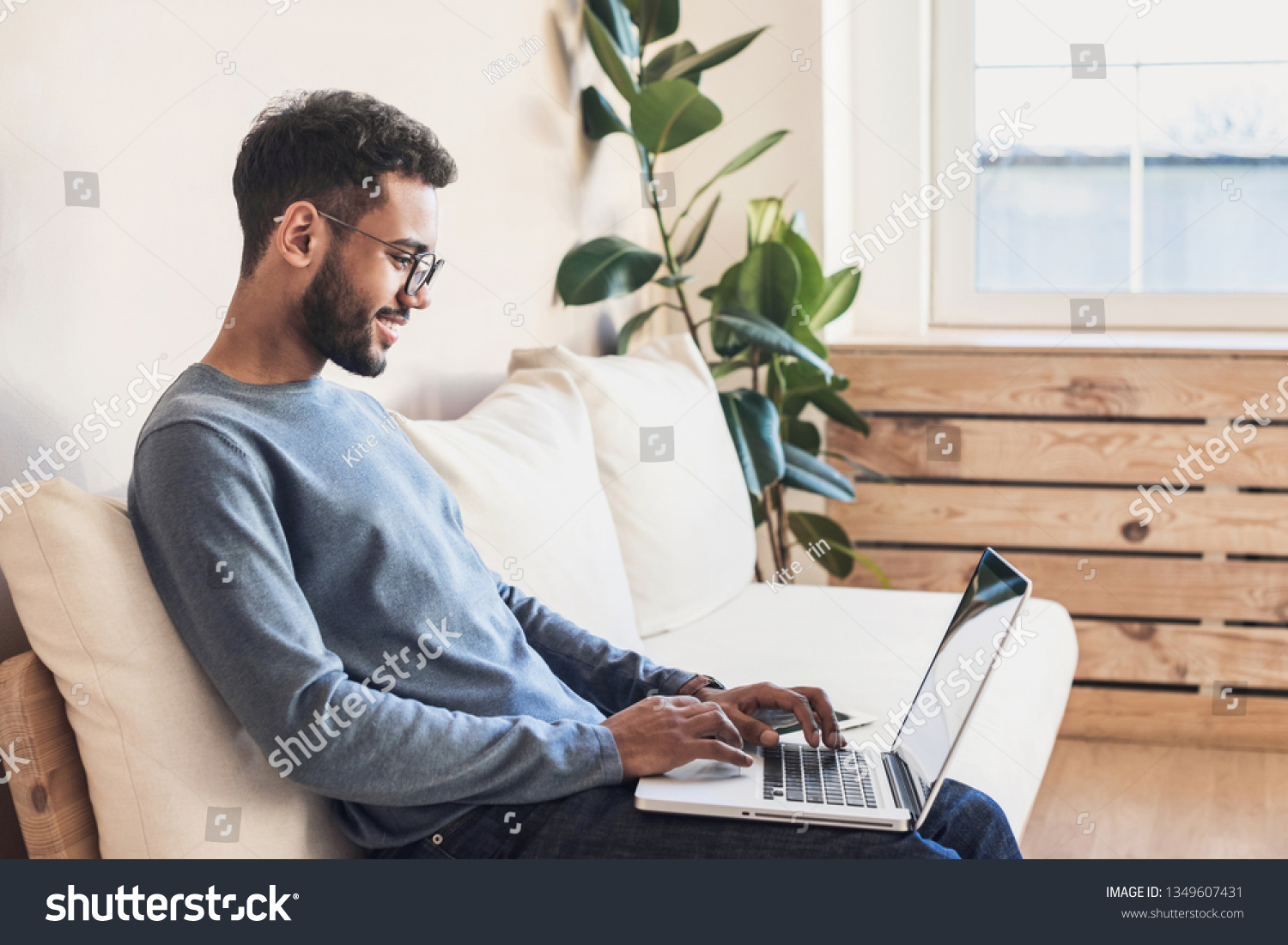 Young man using laptop computer at home.