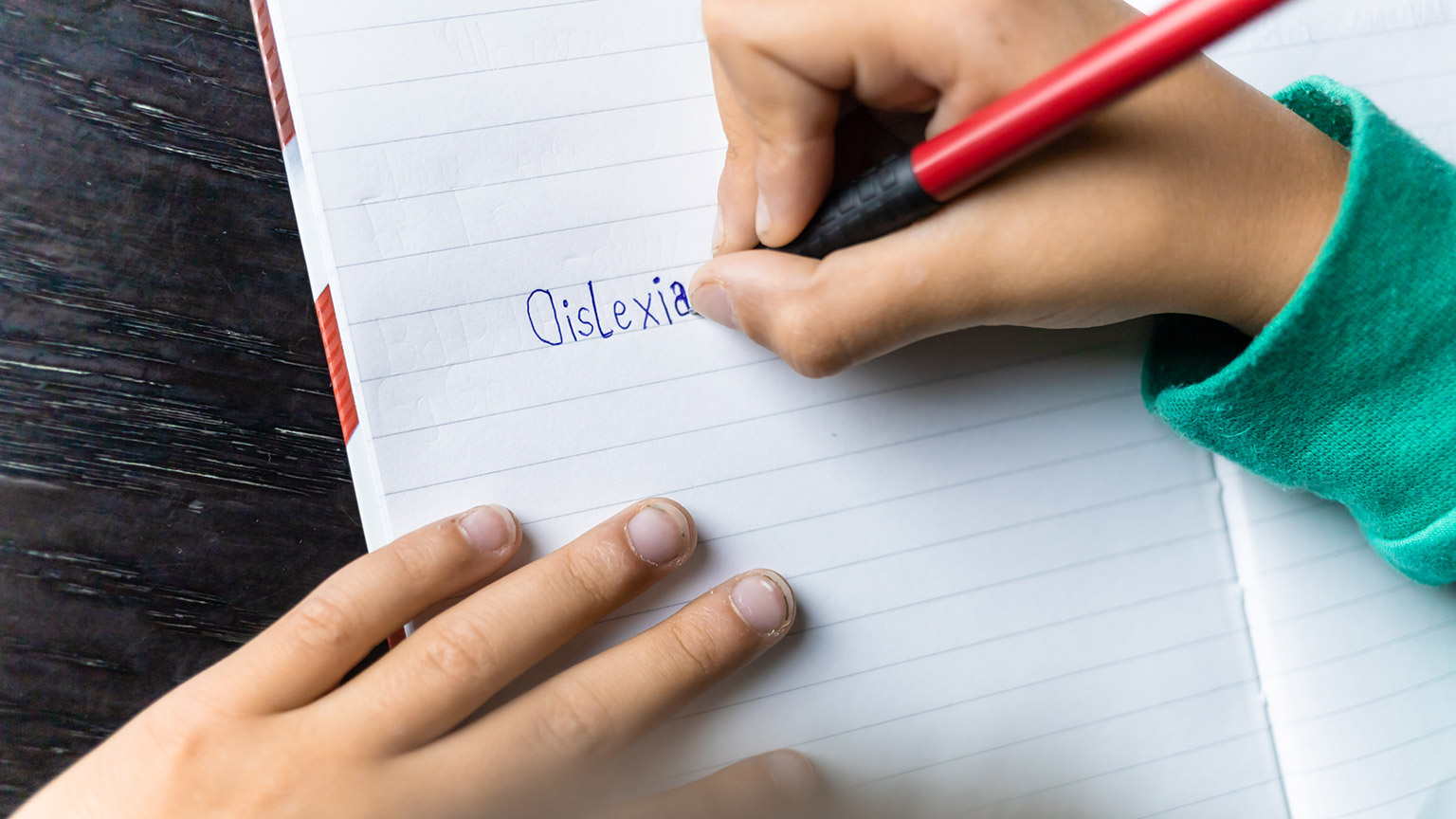 A young child with dyslexia writing