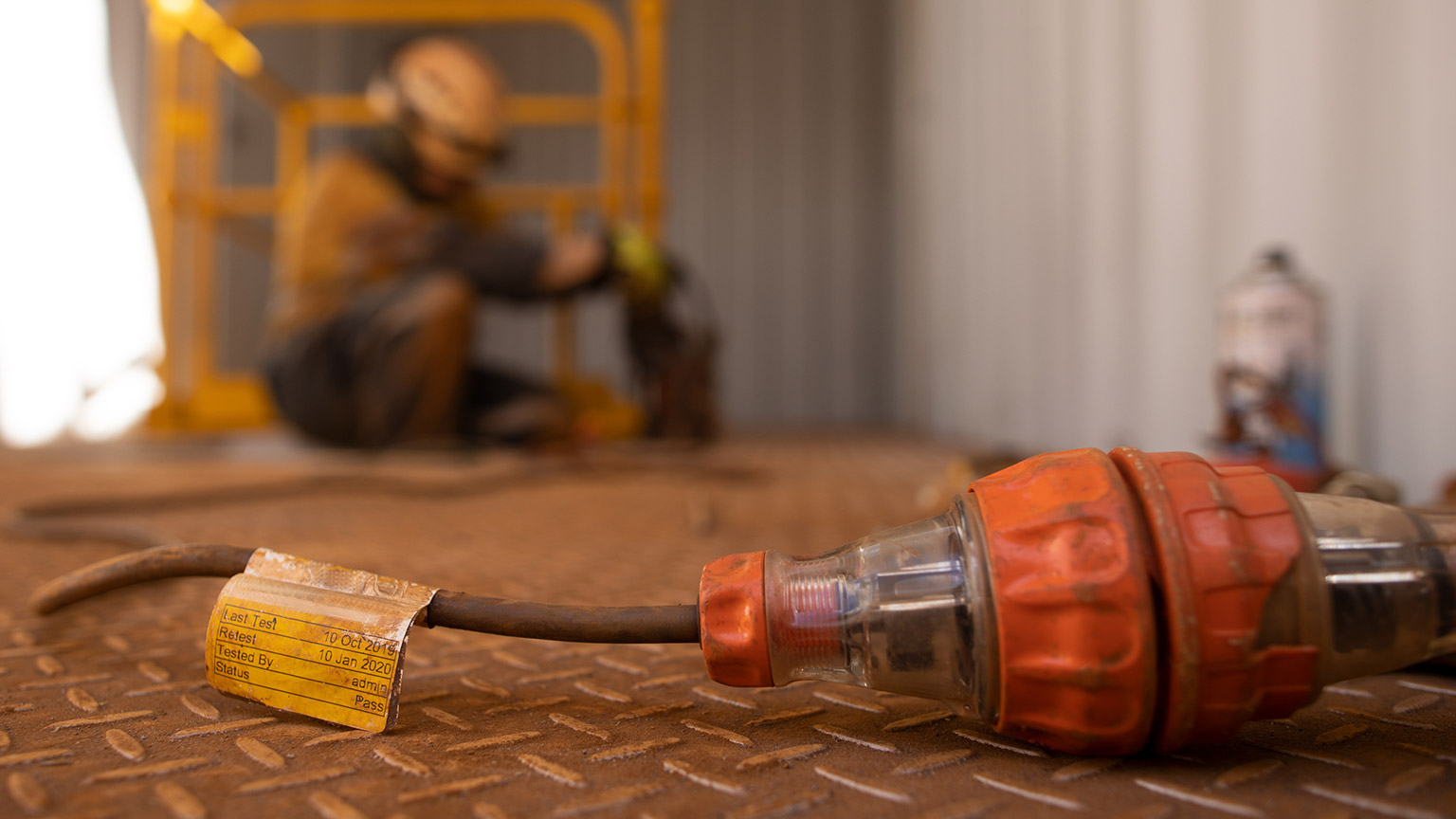 A close view of a tagged power lead on a work site