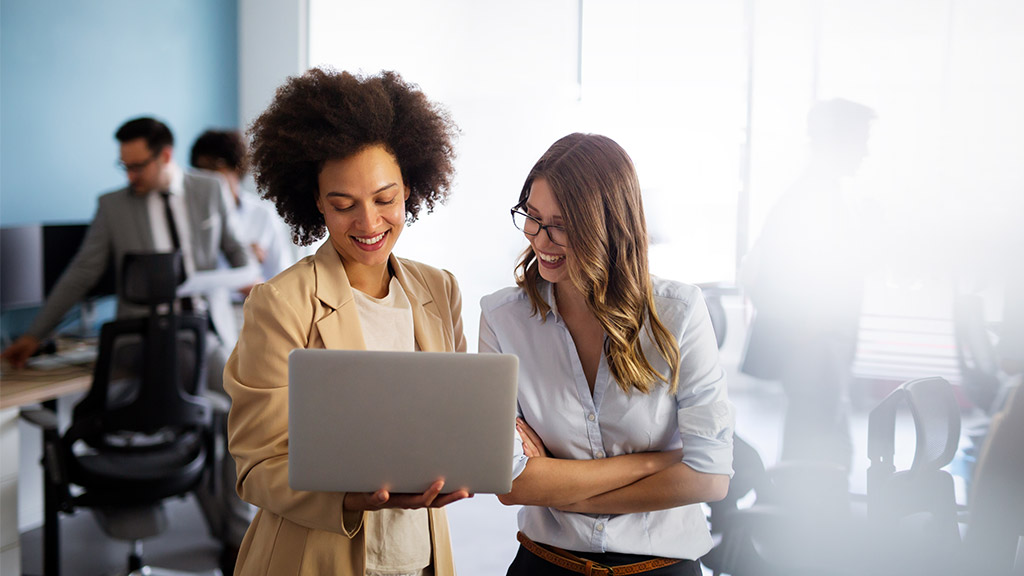 Happy multiethnic smiling business women working together in office