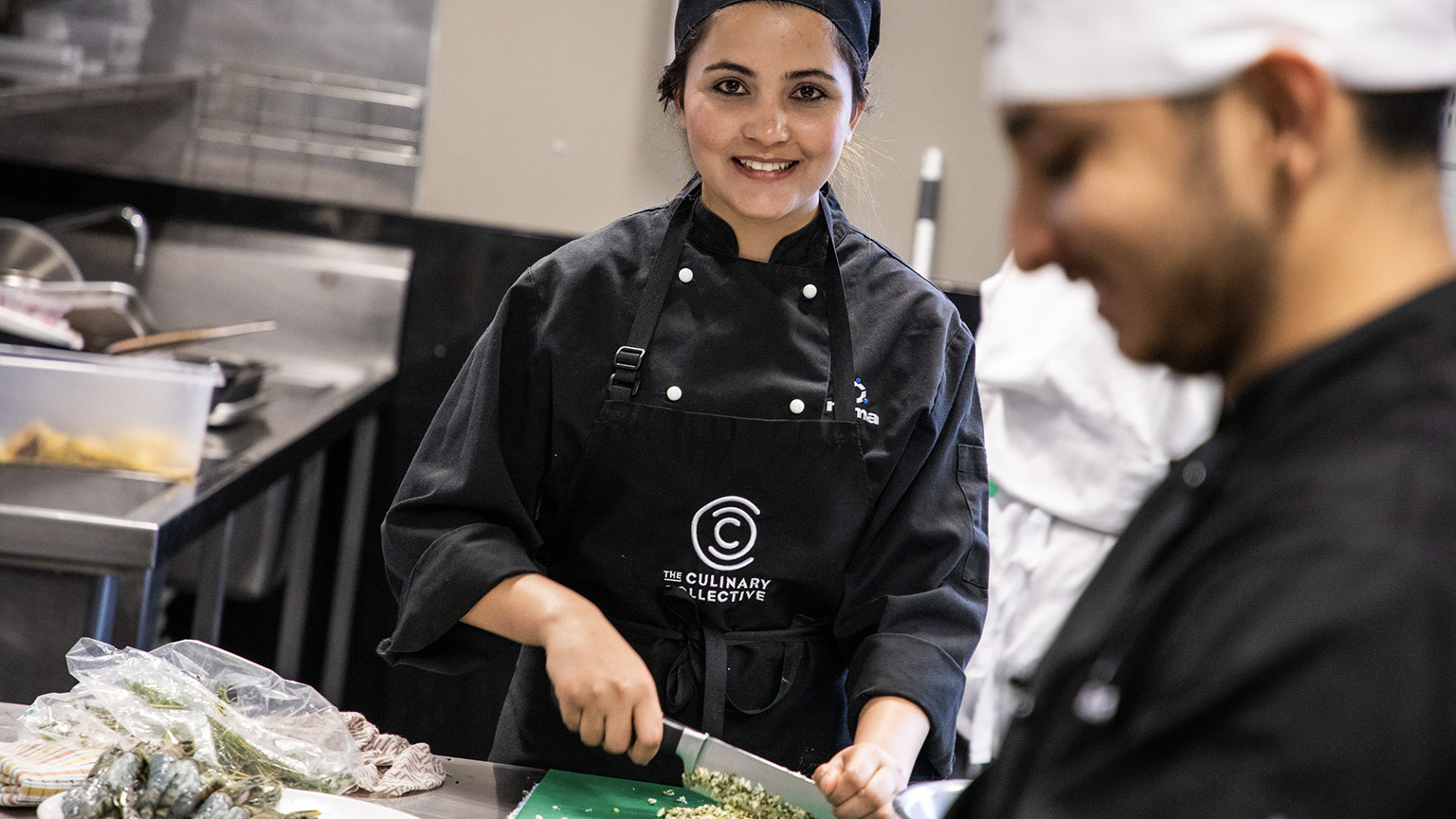 A culinary student cutting up vegetables