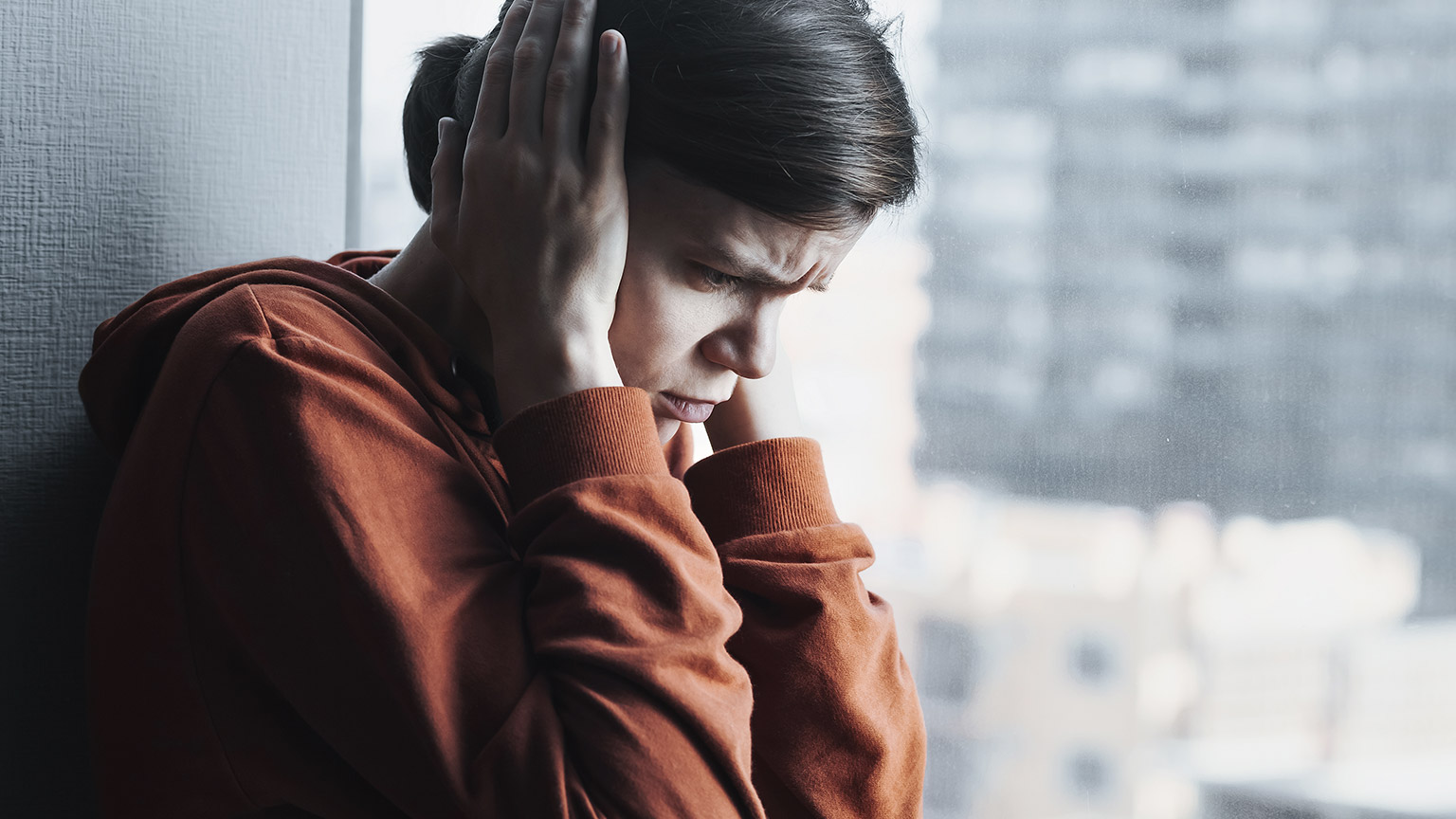 Woman covering her ear; with psychological problem