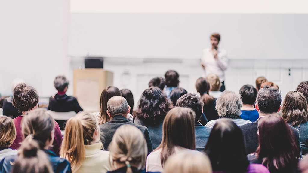 Woman giving presentation on business conference event.