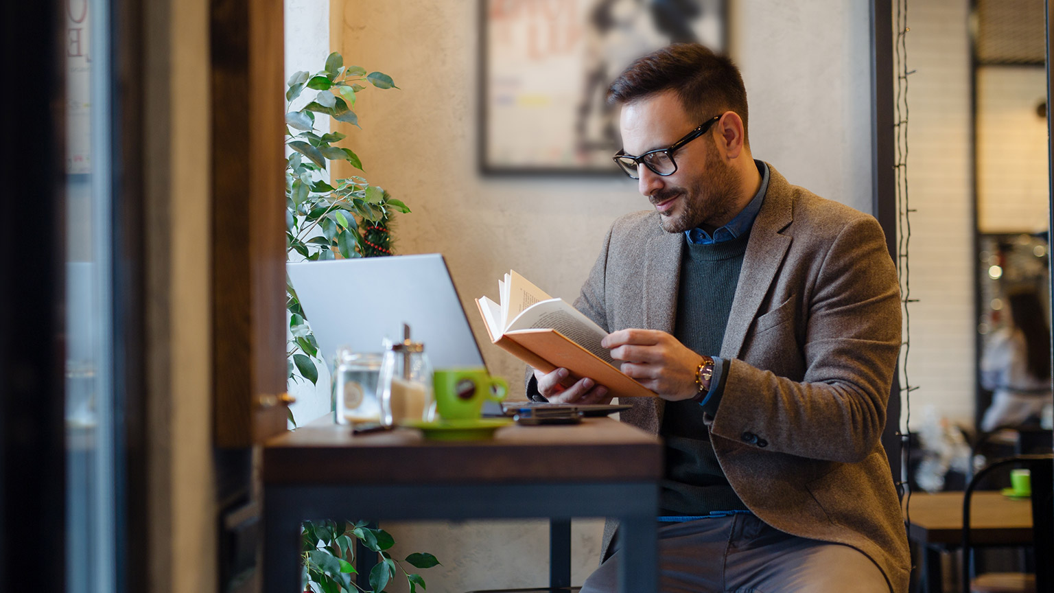 A person sitting at a desk reading