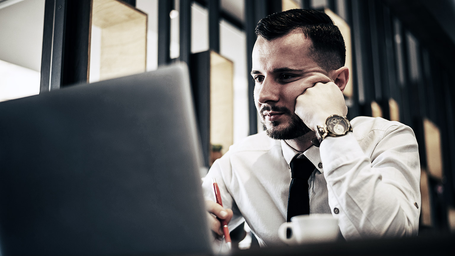 A person focused on thinking critically in an office