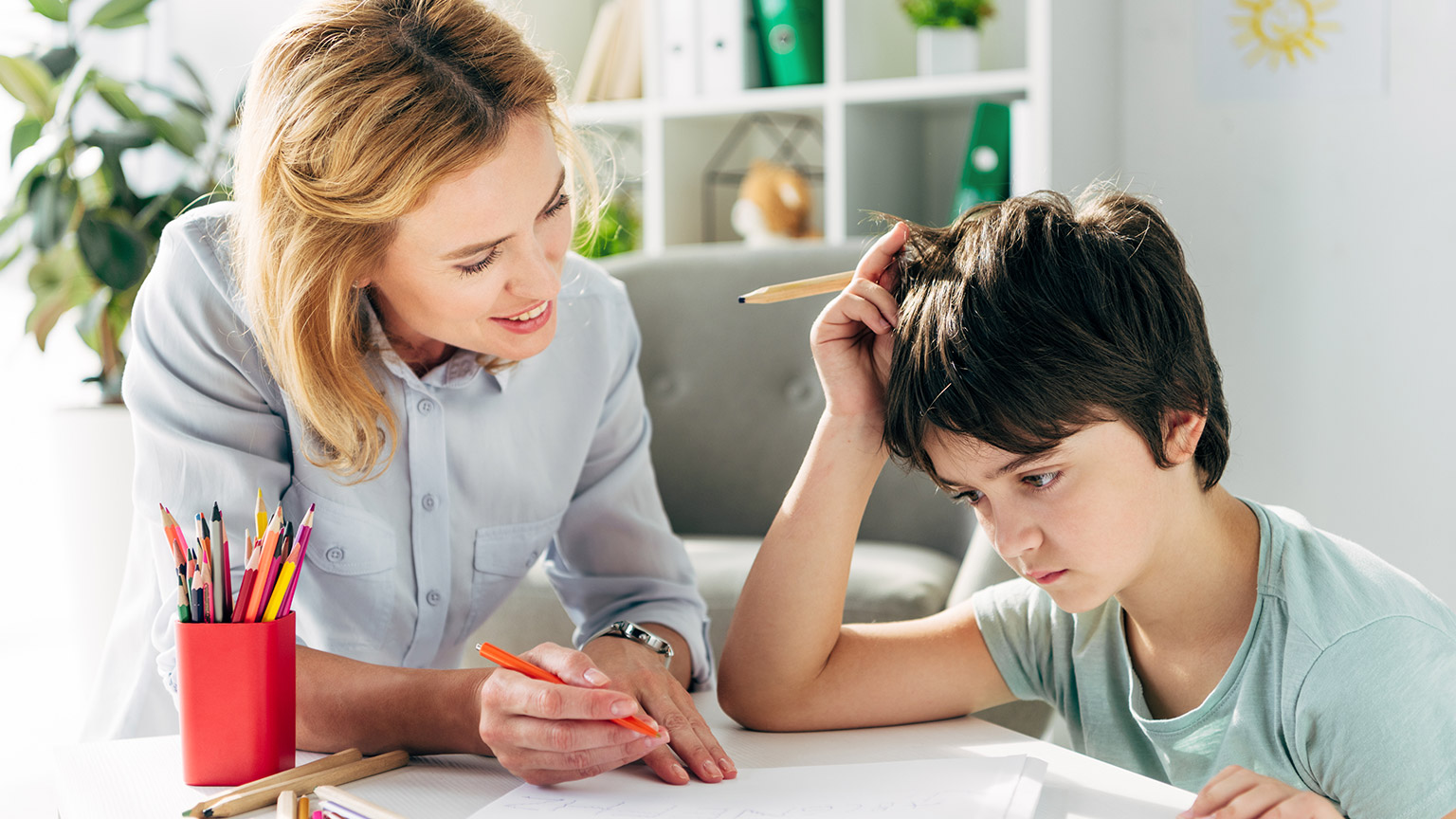 A teacher helping a student with learning difficulties