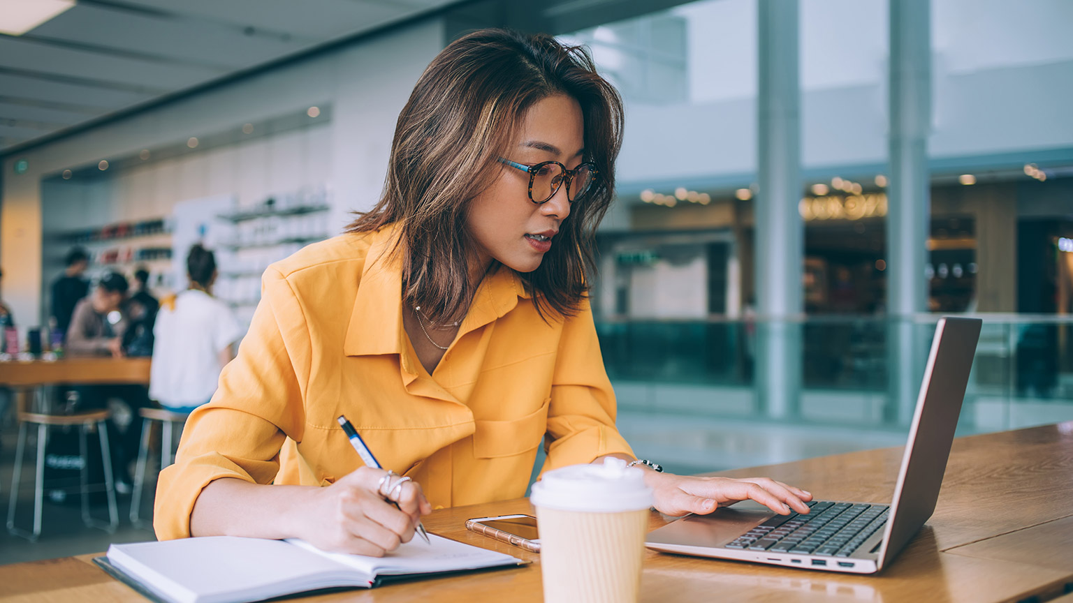 A person reading information from a laptop