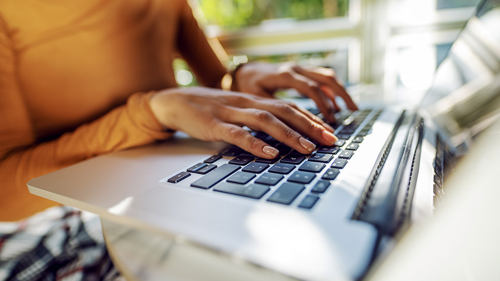 Closeup of woman surfing on internet using her laptop