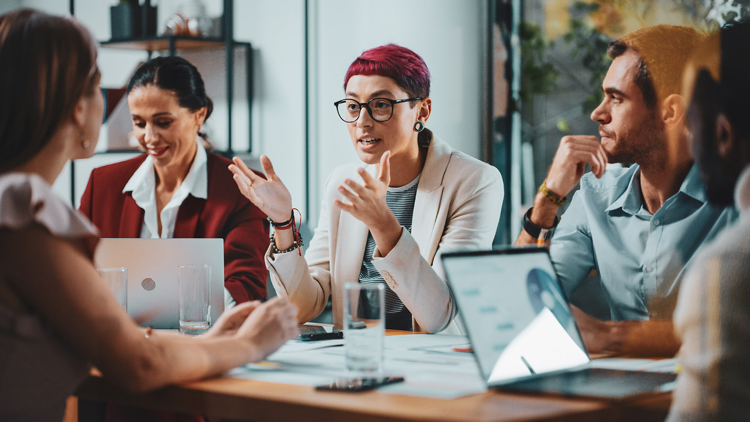 Group of business colleagues sitting at a table discussing business