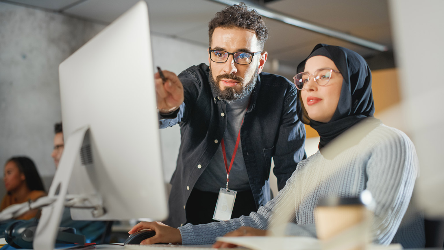 Two IT people working in a modern office