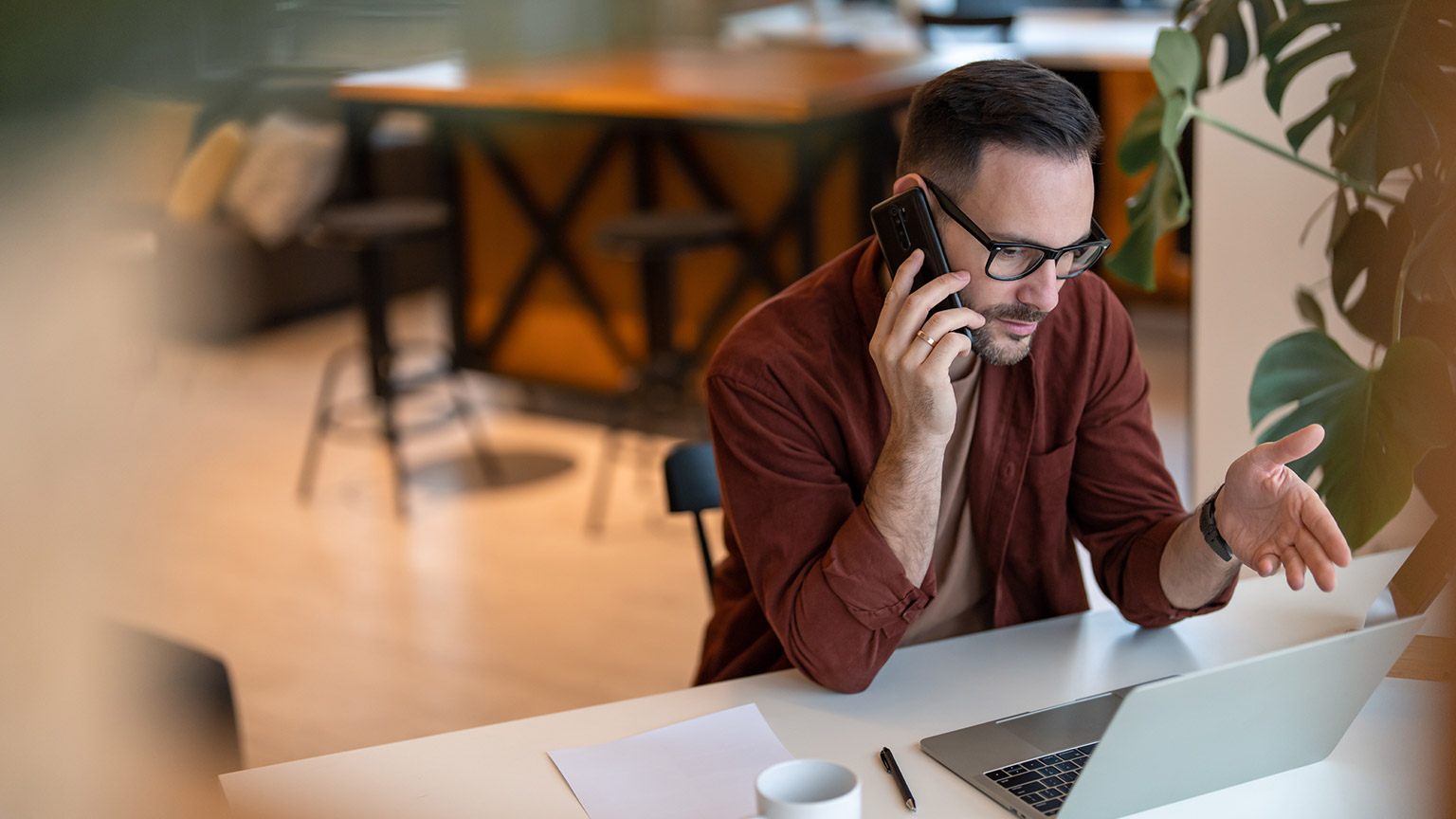 A person talking on a mobile phone in an office