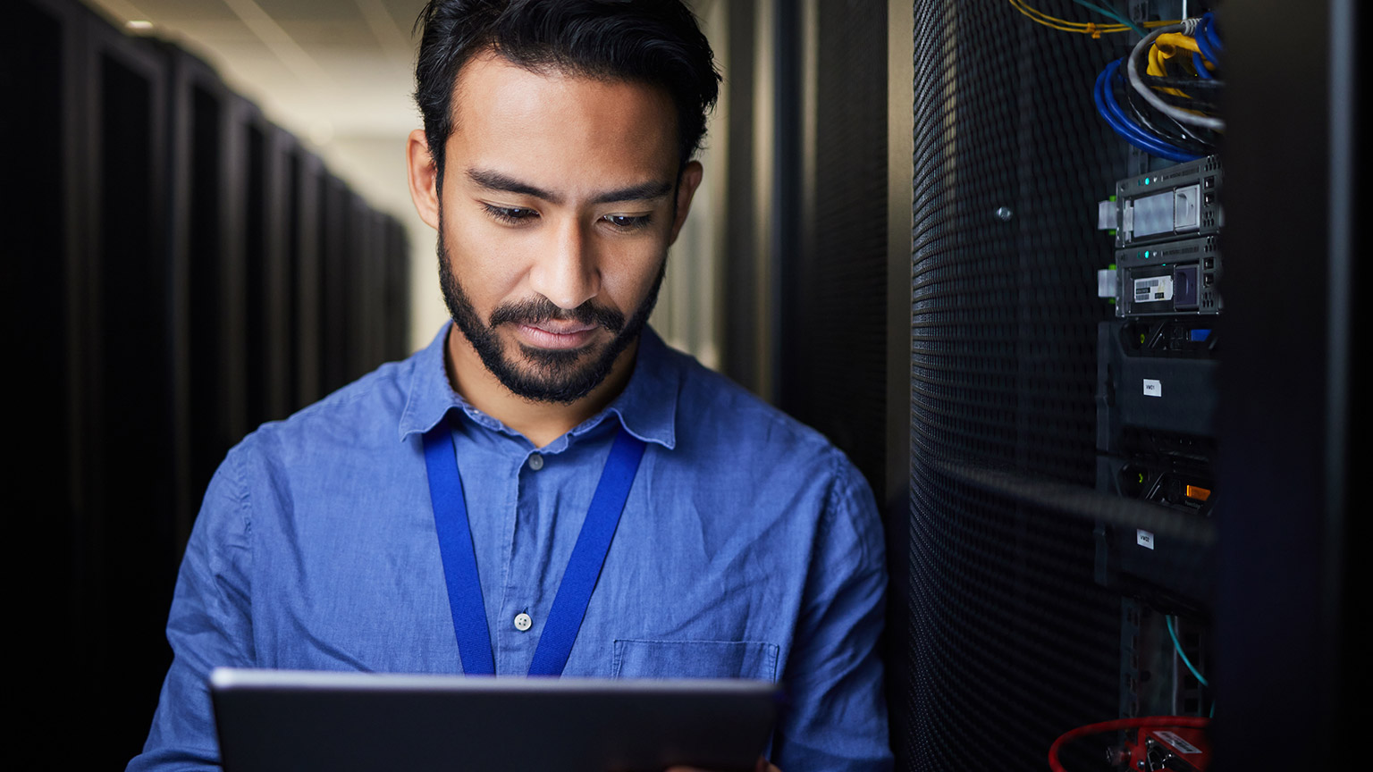 An IT professional checking stuff in a server room