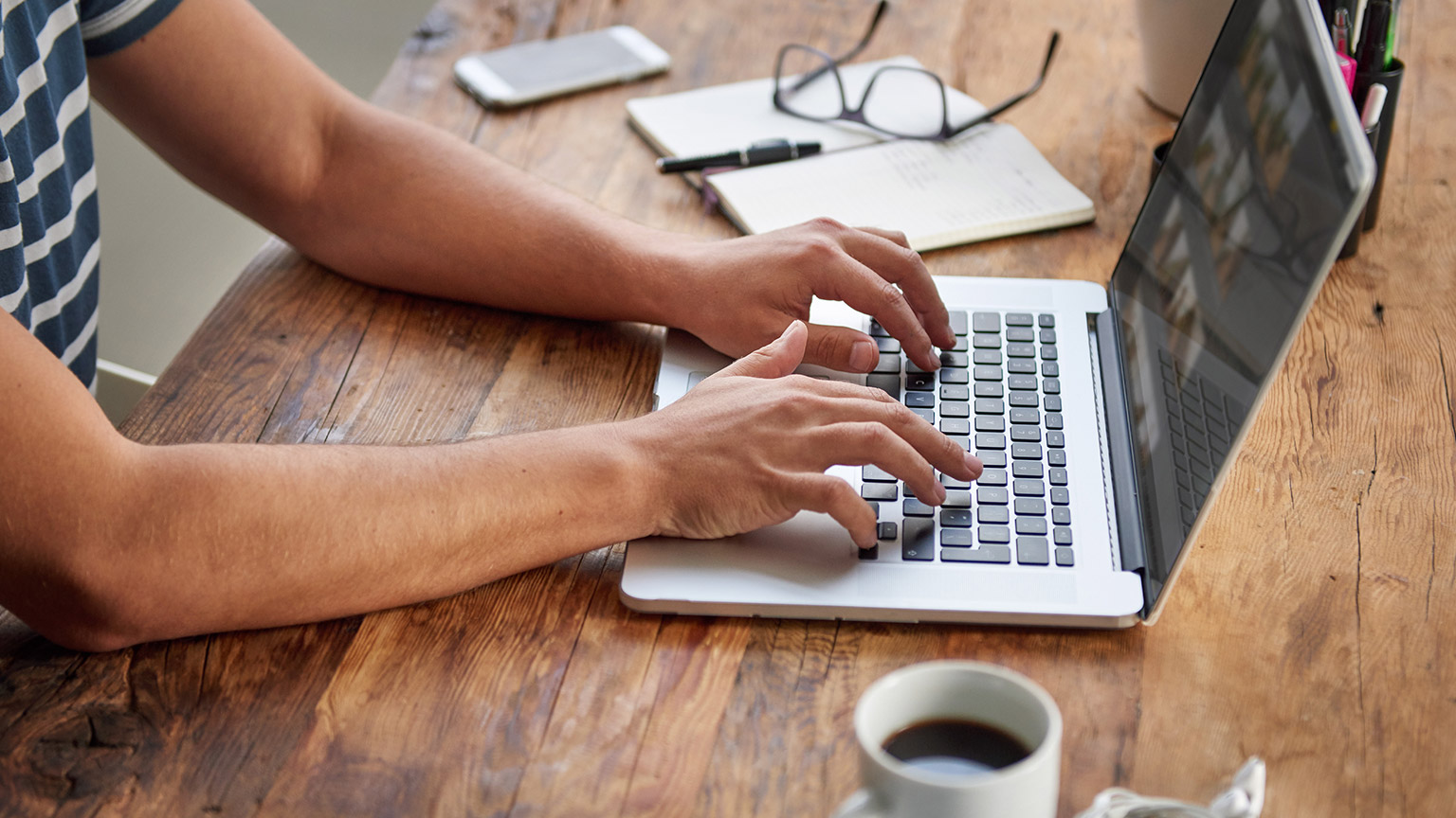 A close view of a person accessing information on a laptop