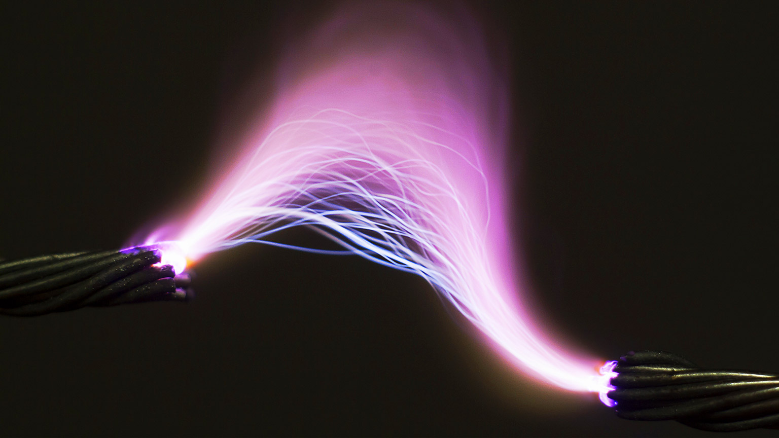 Bright pink electricity arc against a black background