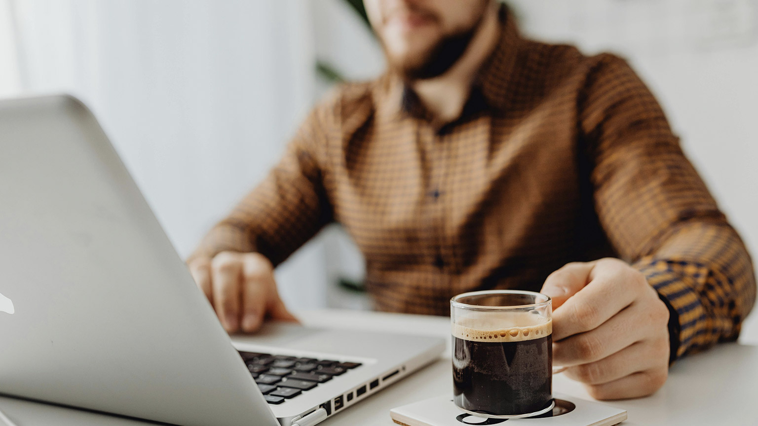 A small business owner researching on a laptop