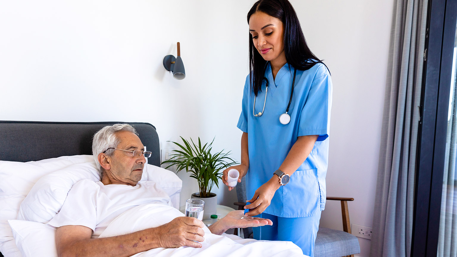 A person receiving medication from a carer